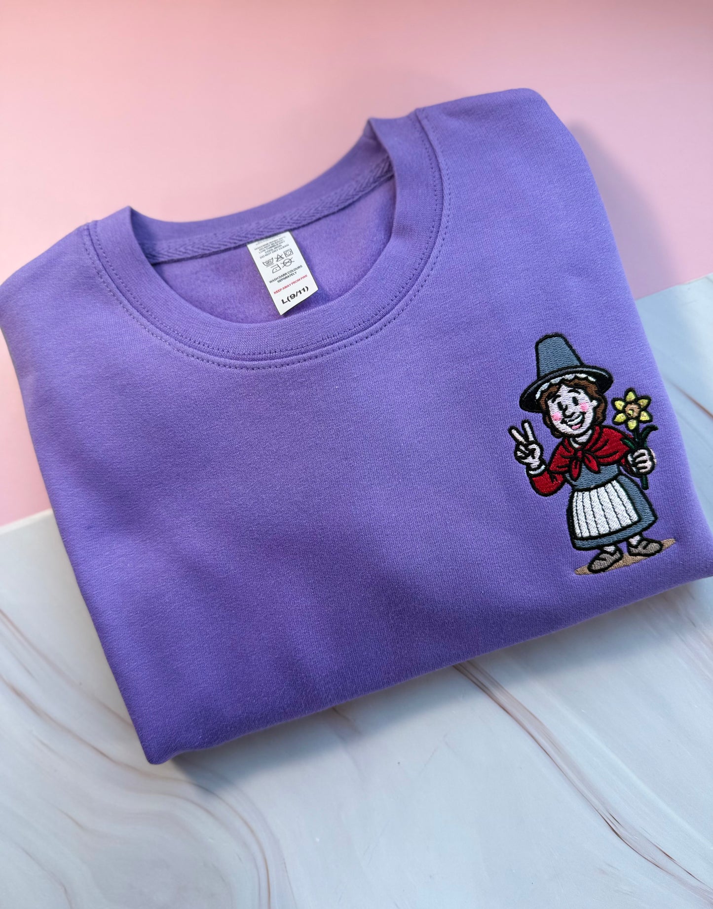 Embroidered digital lavender purple jumper with Welsh lady Miri Machno
