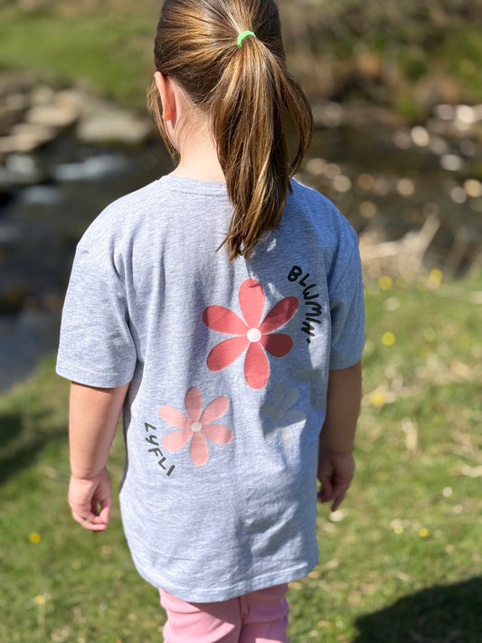 printed trio of flowers with blwmin lyfli on the back of a tshirt